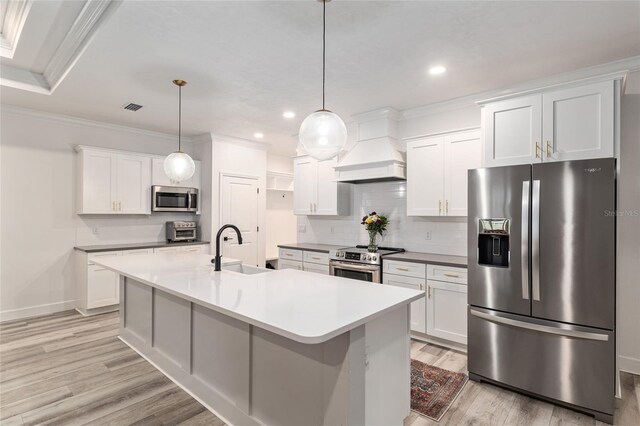 1425 SW 67th Dr, Gainesville, FL 32607 - kitchen with stainless steel appliances, custom range hood, light wood-style flooring, crown molding, and tasteful backsplash