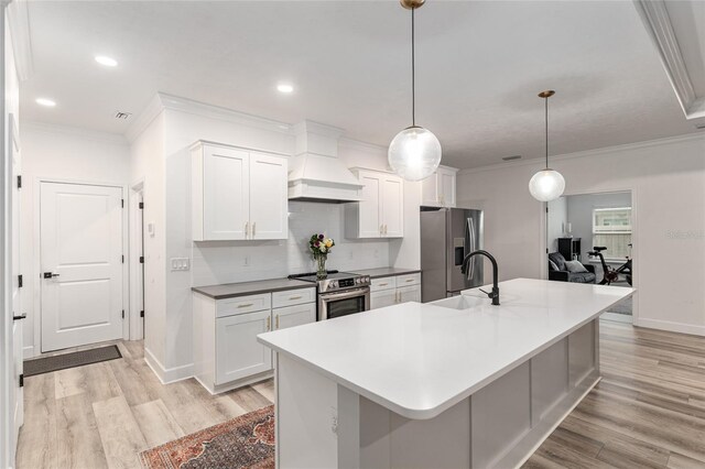 1425 SW 67th Dr, Gainesville, FL 32607 - kitchen with stainless steel appliances, ornamental molding, custom exhaust hood, light wood-style floors, and white cabinetry