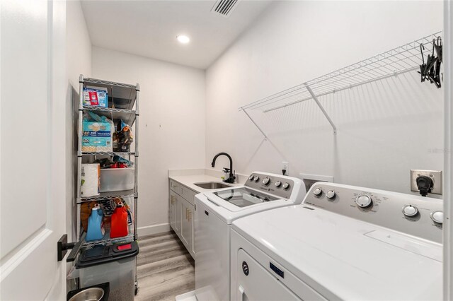 1425 SW 67th Dr, Gainesville, FL 32607 - laundry room with cabinet space, separate washer and dryer, light wood finished floors, and recessed lighting
