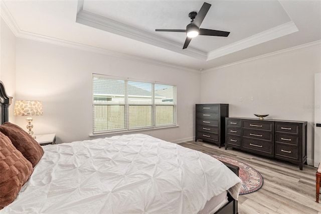 1425 SW 67th Dr, Gainesville, FL 32607 - bedroom with a raised ceiling, light wood-type flooring, crown molding, and a ceiling fan