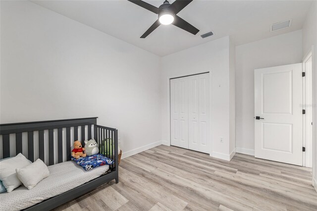 1425 SW 67th Dr, Gainesville, FL 32607 - bedroom featuring light wood-type flooring, a closet, and ceiling fan