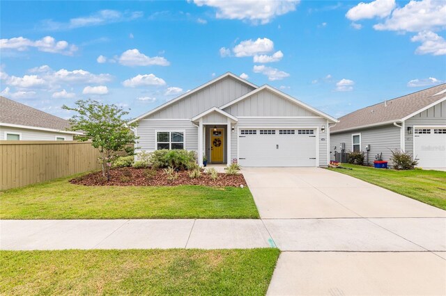 1425 SW 67th Dr, Gainesville, FL 32607 - view of front of property featuring board and batten siding, an attached garage, and driveway