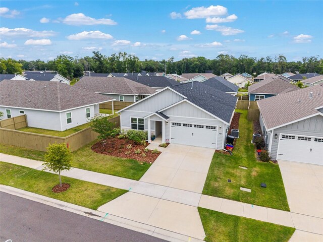1425 SW 67th Dr, Gainesville, FL 32607 - view of front of home featuring board and batten siding, a residential view, a garage, driveway, and a shingled roof