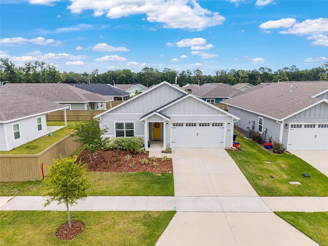 1425 SW 67th Dr, Gainesville, FL 32607 - traditional home with board and batten siding, a garage, driveway, and a residential view