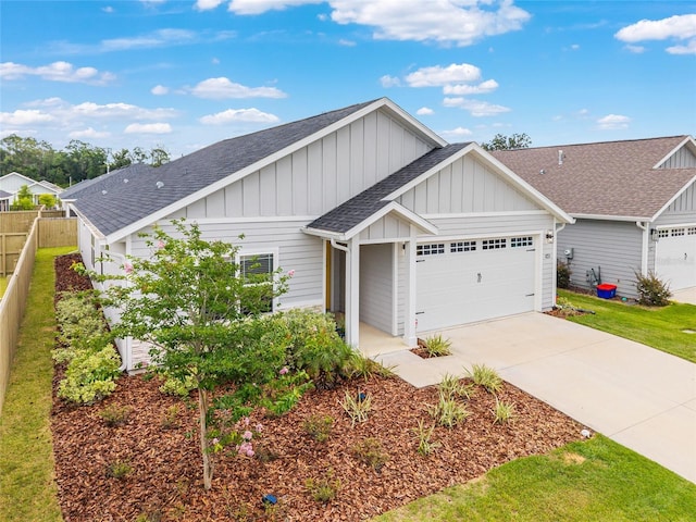 1425 SW 67th Dr, Gainesville, FL 32607 - view of front of property with a shingled roof, board and batten siding, an attached garage, and concrete driveway