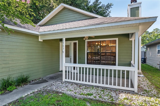 2963 SW 40th Ave, Gainesville, FL 32608 - doorway to property featuring covered porch, a shingled roof, and a chimney