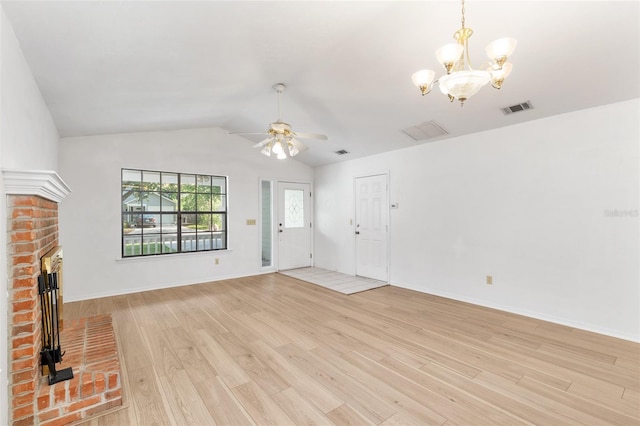 2963 SW 40th Ave, Gainesville, FL 32608 - unfurnished living room with a chandelier, light wood-type flooring, lofted ceiling, a fireplace, and ceiling fan