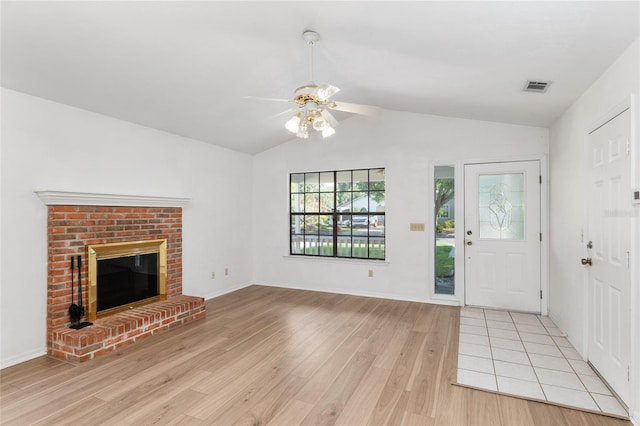 2963 SW 40th Ave, Gainesville, FL 32608 - unfurnished living room featuring vaulted ceiling, ceiling fan, light wood finished floors, and a brick fireplace