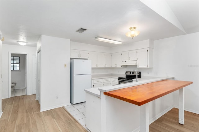 2963 SW 40th Ave, Gainesville, FL 32608 - kitchen featuring freestanding refrigerator, electric range, a peninsula, white cabinets, and light countertops