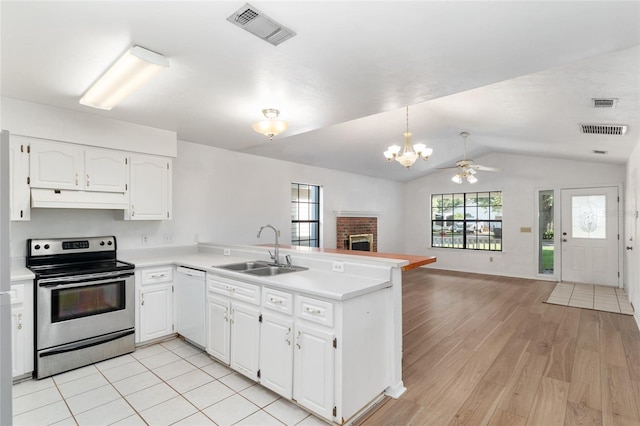 2963 SW 40th Ave, Gainesville, FL 32608 - kitchen with stainless steel range with electric cooktop, dishwasher, under cabinet range hood, a peninsula, and a fireplace