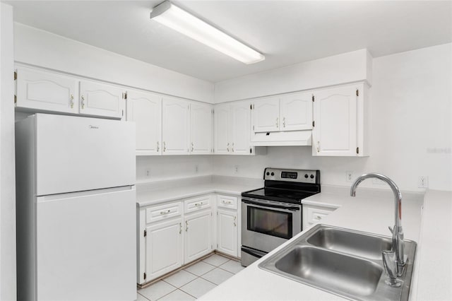 2963 SW 40th Ave, Gainesville, FL 32608 - kitchen featuring freestanding refrigerator, stainless steel electric range oven, custom exhaust hood, and white cabinets