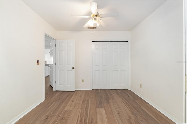 2963 SW 40th Ave, Gainesville, FL 32608 - unfurnished bedroom with light wood-style floors, a closet, and a ceiling fan