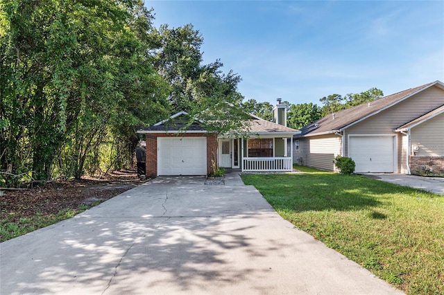2963 SW 40th Ave, Gainesville, FL 32608 - view of front of property featuring a porch, a front yard, concrete driveway, brick siding, and an attached garage