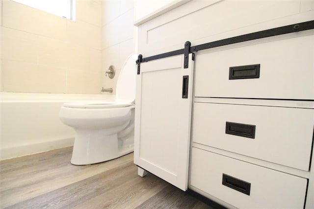 706 NE 24th St, Gainesville, FL 32641 - bathroom featuring wood finished floors and bathing tub / shower combination