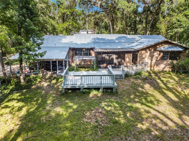 820 NW 109th Dr, Gainesville, FL 32606 - back of property featuring a lawn, brick siding, a metal roof, and a deck