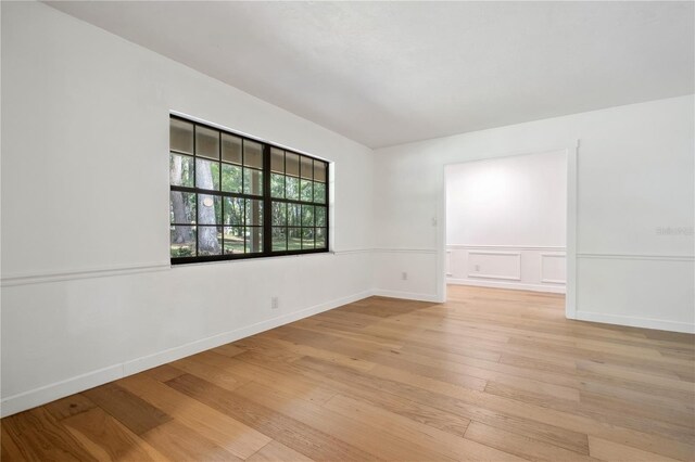 820 NW 109th Dr, Gainesville, FL 32606 - unfurnished room with light wood-style floors and wainscoting