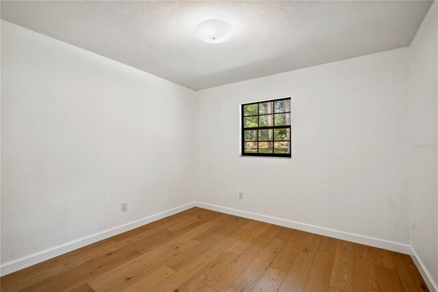 820 NW 109th Dr, Gainesville, FL 32606 - unfurnished room with baseboards and light wood-style floors