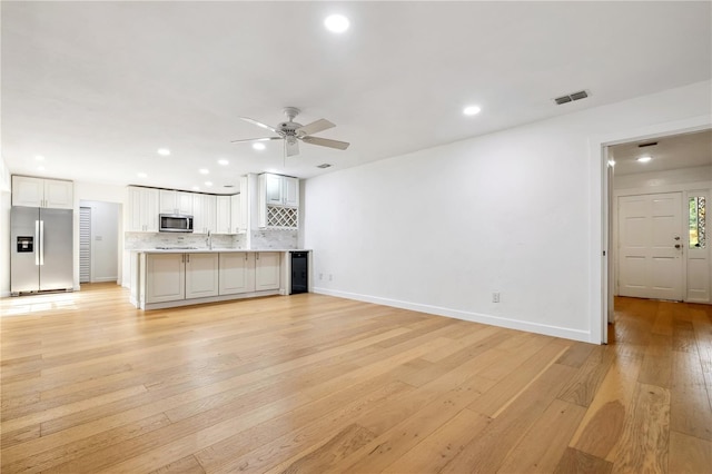 820 NW 109th Dr, Gainesville, FL 32606 - unfurnished living room with light wood-style floors, a ceiling fan, and recessed lighting