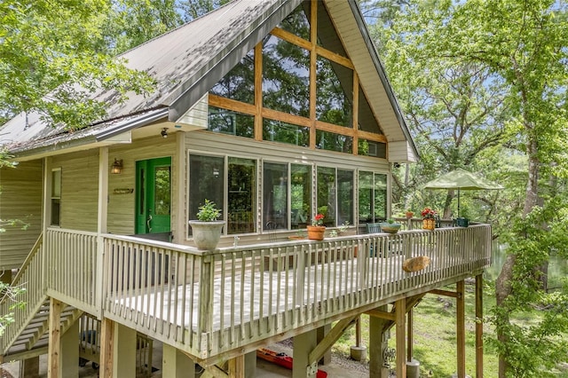 174 SW Meridian Ct, Fort White, FL 32038 - back of property featuring a wooden deck, a metal roof, and stairway