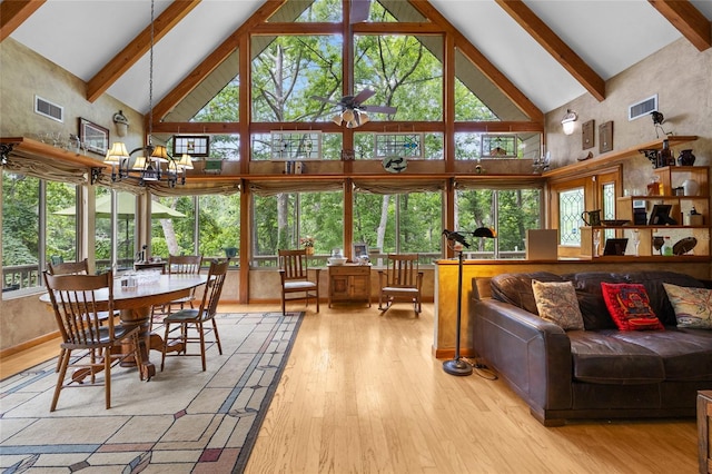 174 SW Meridian Ct, Fort White, FL 32038 - living room featuring high vaulted ceiling, wood finished floors, beamed ceiling, and a chandelier