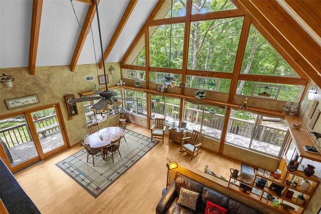 174 SW Meridian Ct, Fort White, FL 32038 - living area featuring high vaulted ceiling, wood finished floors, plenty of natural light, and beam ceiling
