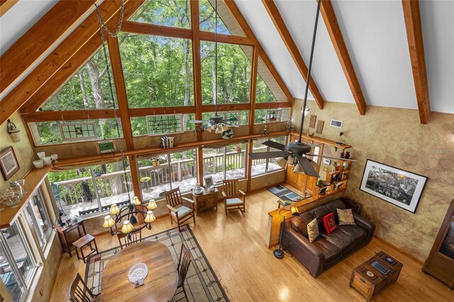 174 SW Meridian Ct, Fort White, FL 32038 - living area featuring high vaulted ceiling, wood finished floors, a ceiling fan, plenty of natural light, and beam ceiling