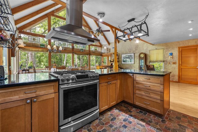 174 SW Meridian Ct, Fort White, FL 32038 - kitchen featuring stainless steel range with gas stovetop, wall chimney range hood, plenty of natural light, brown cabinetry, and recessed lighting