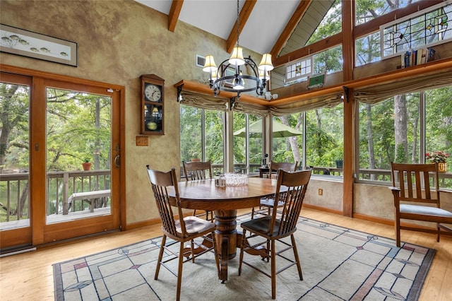 174 SW Meridian Ct, Fort White, FL 32038 - dining area featuring hardwood / wood-style flooring, beam ceiling, a chandelier, and high vaulted ceiling