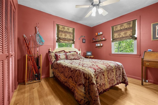 174 SW Meridian Ct, Fort White, FL 32038 - bedroom featuring light wood-style flooring, multiple windows, and ceiling fan