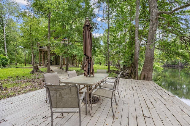 174 SW Meridian Ct, Fort White, FL 32038 - deck featuring a water view, outdoor dining area, and view of wooded area