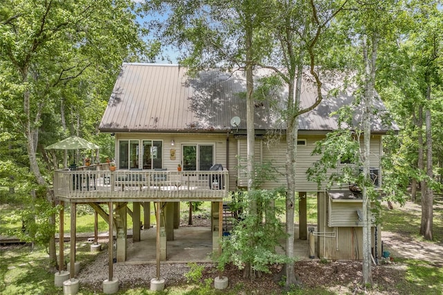 174 SW Meridian Ct, Fort White, FL 32038 - back of house with a deck, a patio, stairway, and a metal roof