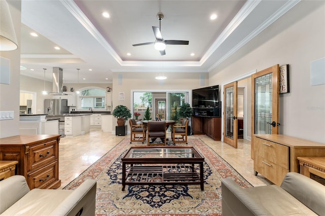 552 NW 136th St, Newberry, FL 32669 - living room featuring a tray ceiling, french doors, a ceiling fan, ornamental molding, and recessed lighting