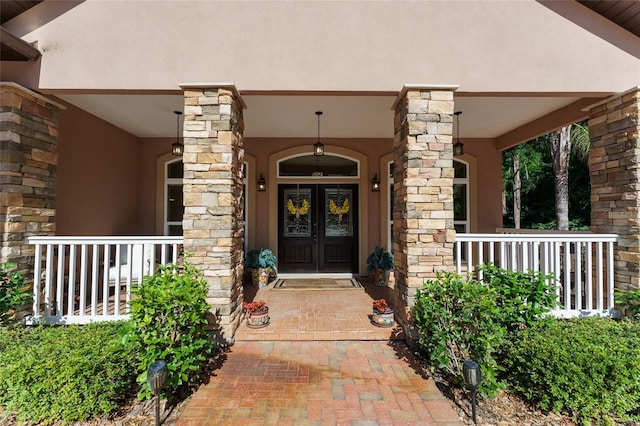 552 NW 136th St, Newberry, FL 32669 - entrance to property with french doors, stucco siding, and a porch