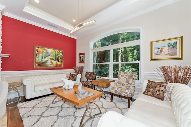 552 NW 136th St, Newberry, FL 32669 - living room featuring wood finished floors, ornamental molding, wainscoting, a decorative wall, and a tray ceiling