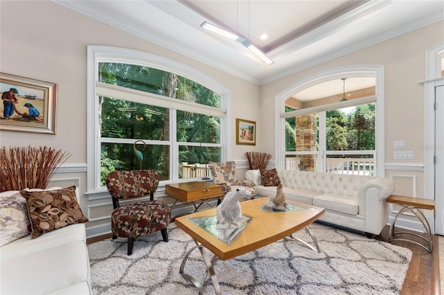 552 NW 136th St, Newberry, FL 32669 - living room featuring ornamental molding, wood finished floors, healthy amount of natural light, a decorative wall, and a wainscoted wall