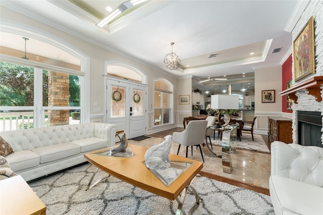 552 NW 136th St, Newberry, FL 32669 - living room featuring a tray ceiling, ornamental molding, a decorative wall, a ceiling fan, and recessed lighting