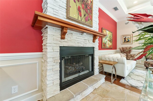 552 NW 136th St, Newberry, FL 32669 - living area with crown molding, a fireplace, a wainscoted wall, and wood finished floors