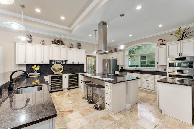 552 NW 136th St, Newberry, FL 32669 - kitchen with beverage cooler, island exhaust hood, appliances with stainless steel finishes, a center island, and crown molding