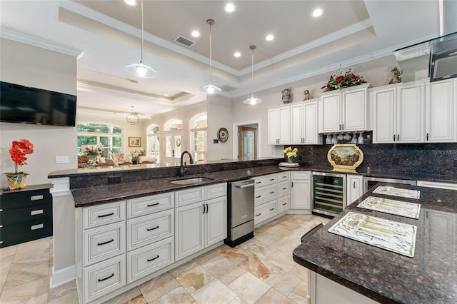 552 NW 136th St, Newberry, FL 32669 - kitchen featuring wine cooler, a tray ceiling, a peninsula, ornamental molding, and dishwasher