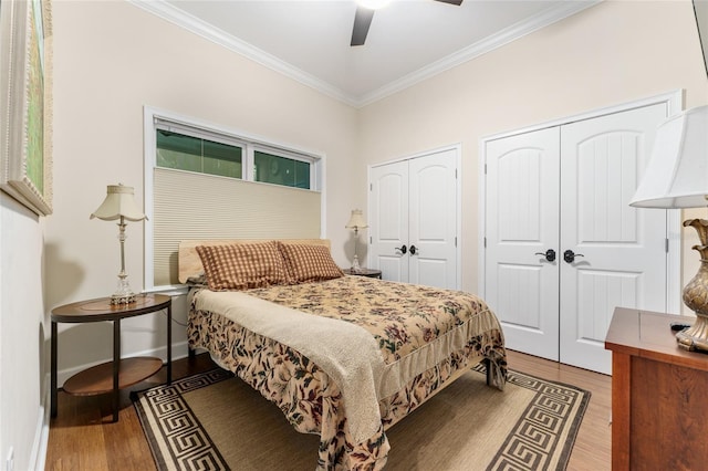 552 NW 136th St, Newberry, FL 32669 - bedroom featuring ornamental molding, two closets, wood finished floors, and ceiling fan