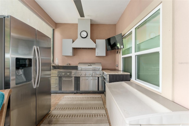 552 NW 136th St, Newberry, FL 32669 - kitchen with stainless steel fridge, premium range hood, light wood-style floors, and light countertops