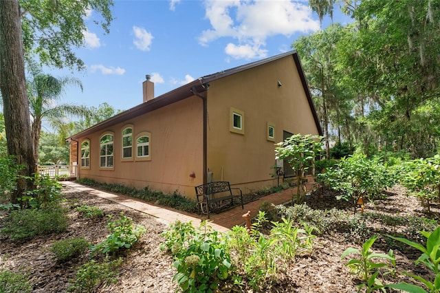 552 NW 136th St, Newberry, FL 32669 - view of side of property with a chimney