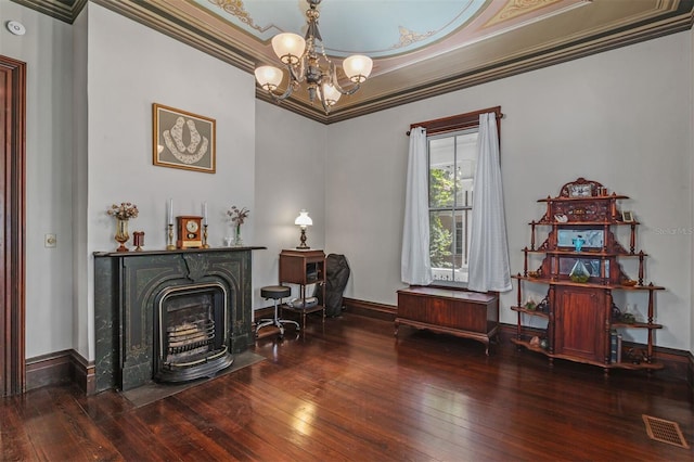 708 E University Ave, Gainesville, FL 32601 - sitting room featuring hardwood / wood-style floors, a chandelier, ornamental molding, and a fireplace with flush hearth