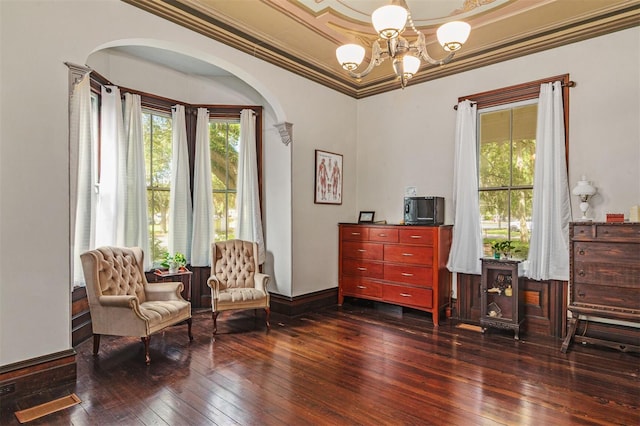 708 E University Ave, Gainesville, FL 32601 - sitting room with dark wood-style floors, a chandelier, arched walkways, plenty of natural light, and ornamental molding