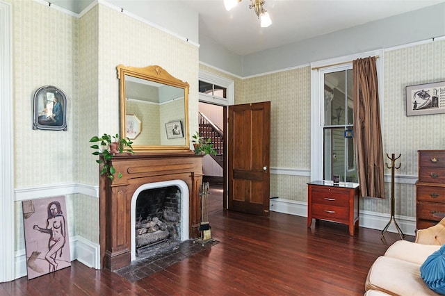 708 E University Ave, Gainesville, FL 32601 - living area with wallpapered walls, dark wood finished floors, stairway, and a fireplace with flush hearth
