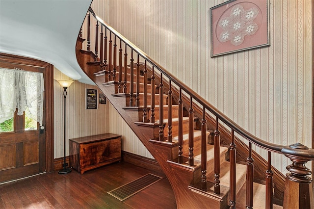708 E University Ave, Gainesville, FL 32601 - stairs featuring hardwood / wood-style floors and wallpapered walls