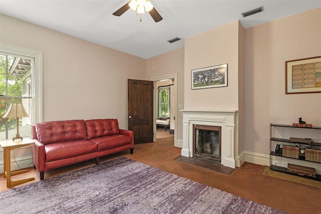 708 E University Ave, Gainesville, FL 32601 - living area with carpet flooring, ceiling fan, plenty of natural light, and a fireplace with flush hearth