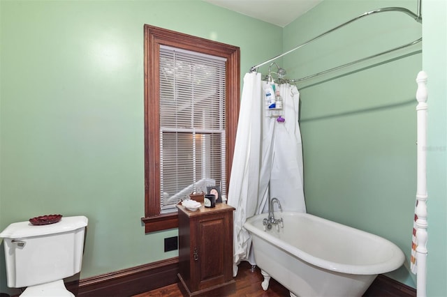 708 E University Ave, Gainesville, FL 32601 - bathroom with a freestanding bath, wood finished floors, and a shower with shower curtain
