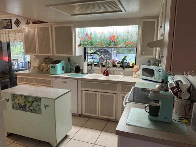 8411 N Pine Needle Ter, Crystal River, FL 34428 - kitchen featuring light countertops, light tile patterned floors, a kitchen island, and dishwasher