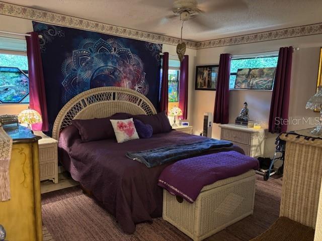 8411 N Pine Needle Ter, Crystal River, FL 34428 - bedroom featuring multiple windows and ceiling fan